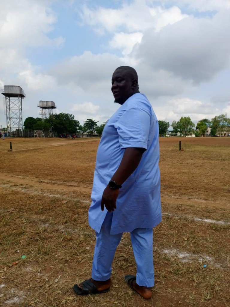 Olalekan Razaq walking a land site during property inspection